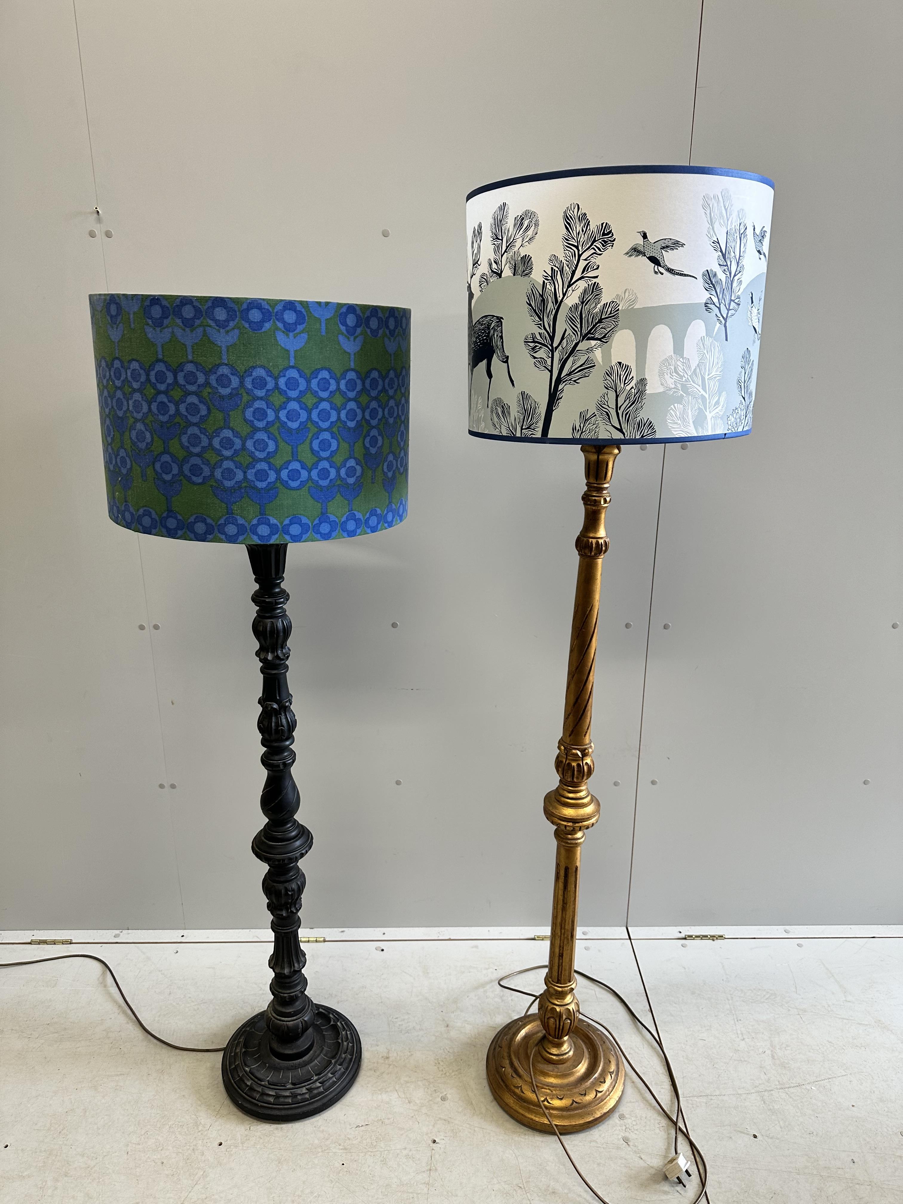 A Victorian style painted standard lamp and shade together with a giltwood standard lamp with shade, larger height 178cm